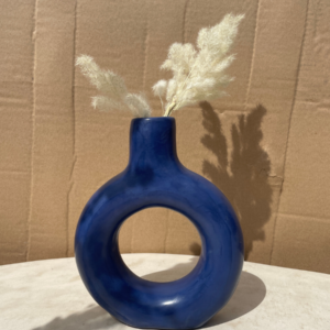 Handmade round blue ceramic vase with hollow center and modern sculptural decorative design